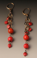 earrings of coral dangling from oxidized sterling silver